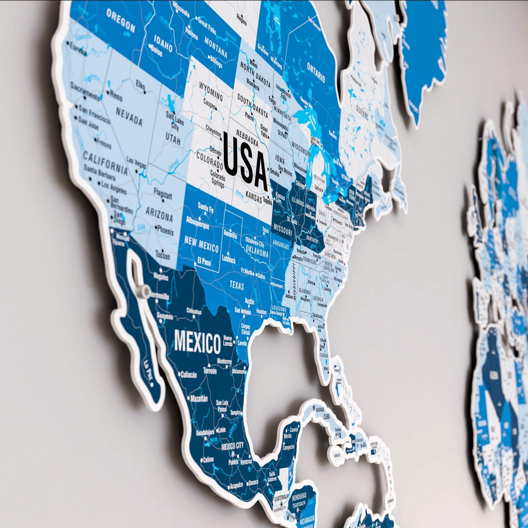 a copper colored metal world map wall art that features countries' names hanged on a grey wall
