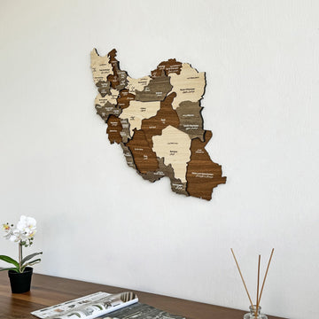 Iran wooden wall map seen from the left above a sideboard with a reed diffuser