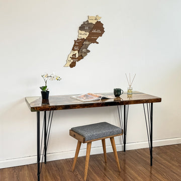 Lebanon wooden wall map hung over a desk, with the stool turned slightly to the side