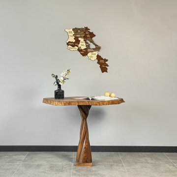 Armenia wooden wall map high on a gray wall above a twisted-base wooden table, wide view