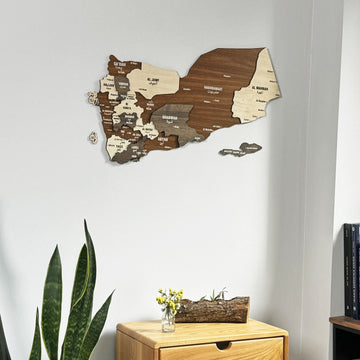 Yemen wooden wall map in a medium close view above a wooden chest of drawers with flowers in a glass