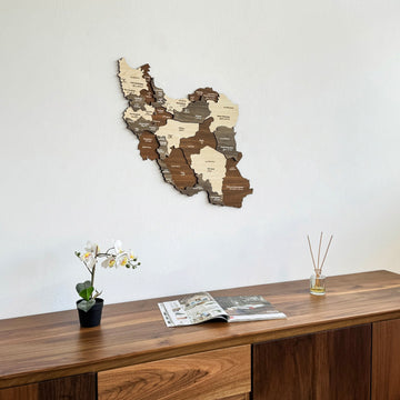 Iran wooden wall map with province names on a white wall above a walnut sideboard
