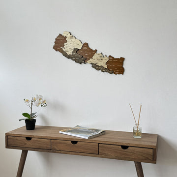 Nepal wooden wall map in a medium close view above a three-drawer console with an orchid