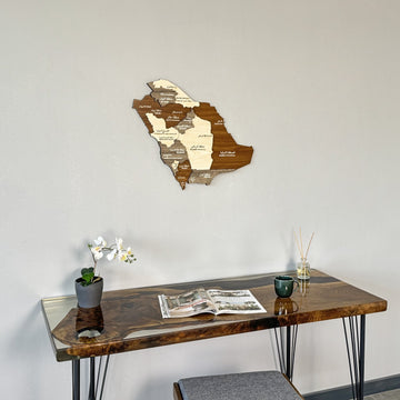 Saudi Arabia wooden wall map in a mid-distance shot over a desk with a diffuser