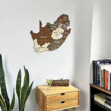 South Africa wooden wall map seen from slightly below, above a small drawer table