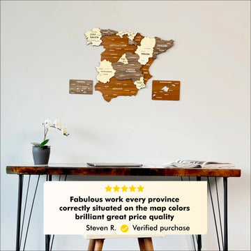 Mixed color Spain wooden wall map above a desk with a five-star customer review about provinces and map colors