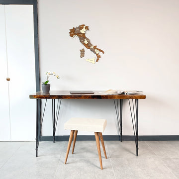 Multicolor wooden Italy wall map above a hairpin-leg desk with a white stool, wide room view