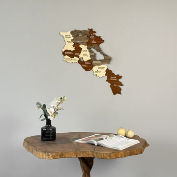 Armenia wooden wall map above a live-edge wooden table with a vase of flowers, close view