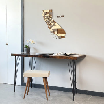 California wooden wall map above a hairpin-leg desk with a white door frame at left
