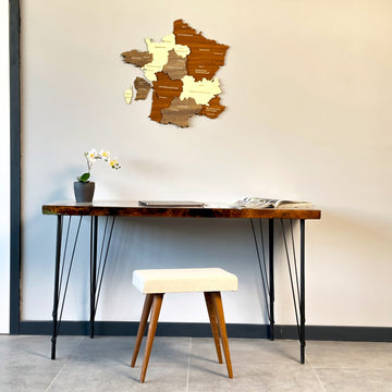 France wooden wall map on a white wall above a hairpin-leg desk and a cream stool, wide view