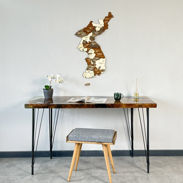 Small Korea wooden wall map above a desk with a gray stool