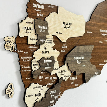 Close-up of the Yemen wooden wall map showing Sa'dah, Hajjah, Sana'a, Taizz and Aden labels in English and Arabic