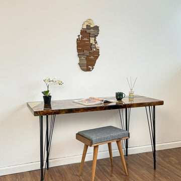 Qatar wooden wall map hung over a desk with a stool pulled out, mid-distance view