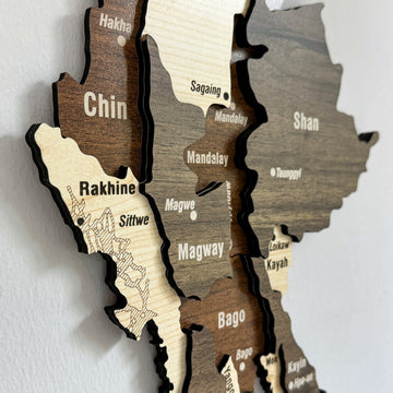 Close-up of the Myanmar wooden wall map showing Chin, Rakhine, Magway, Mandalay and Shan in layered wood