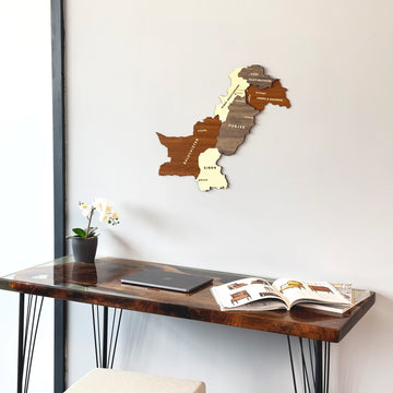 Pakistan wooden wall map in layered brown and cream wood above a resin desk