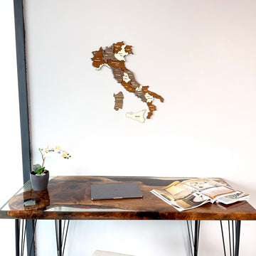 Layered wooden Italy map with Sicily and Sardinia above the corner of a walnut resin desk