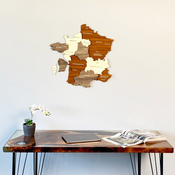 France wooden wall map above a walnut resin desk with an orchid