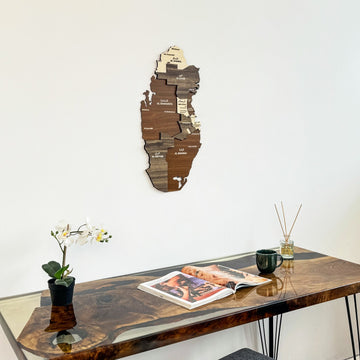 Qatar wooden wall map seen from a low angle above a resin desk with an open magazine