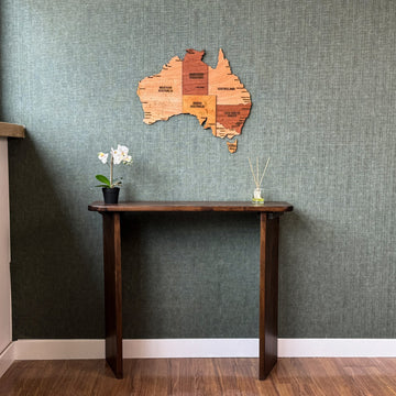 Australia wooden wall map above a dark wood console, full-length view to the floor
