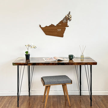 United Arab Emirates wooden wall map above a desk with a gray stool, wide view