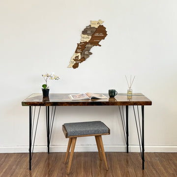 Lebanon wooden wall map centered over a desk, with a stool pulled under it, wide shot