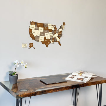 USA wood wall map above a desk with an orchid, tight crop