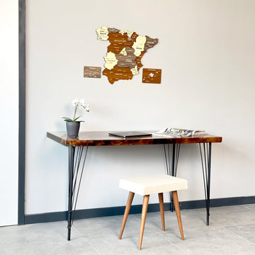 Mixed color Spain wooden wall map above a desk with a cream stool, wide view