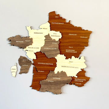 France wooden wall map with region names in cream, tan and brown wood layers, straight-on view