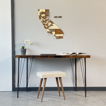 California wooden wall map with CALIFORNIA lettering above a live-edge desk, wide view