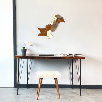 Pakistan wooden wall map above a hairpin-leg desk with a cream stool