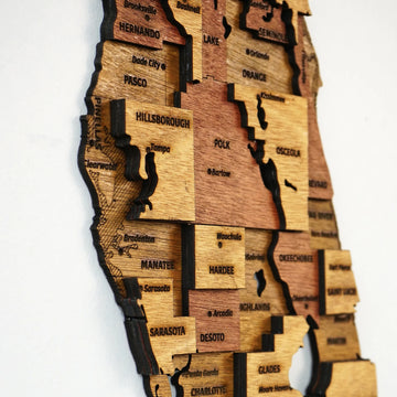 Angled close-up of the wooden Florida map showing stacked county layers around Hillsborough, Polk and Osceola