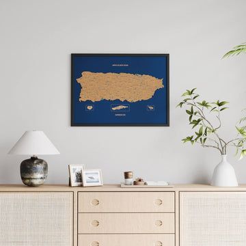 Black-framed Puerto Rico cork map without photos, above a lamp and a rattan sideboard