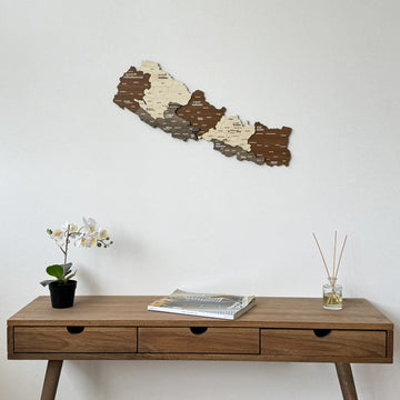 Nepal wooden wall map with province names above a walnut console with three drawers