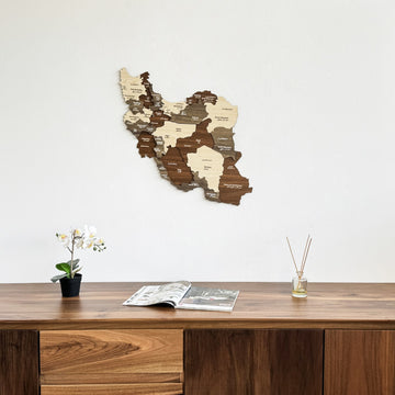 Iran wooden wall map above a walnut sideboard, closer view of the sideboard top with a diffuser