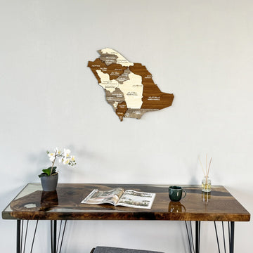 Saudi Arabia wooden wall map above a resin-edged wood desk with an orchid, wide view