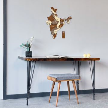 Wide room view with the multicolor wooden India map above a dark desk