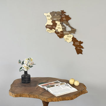 Armenia layered wooden wall map above a live-edge table, seen from a low left angle
