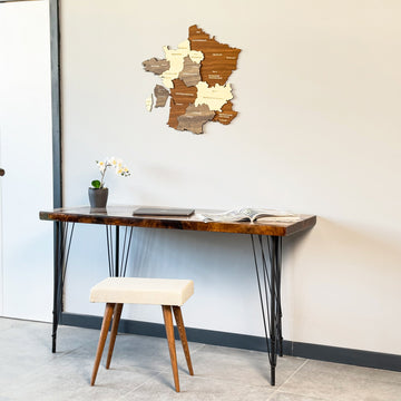 Small France wooden wall map above a desk and stool, seen from a lower angle