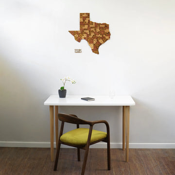Wooden Texas map above a white desk with a green-seat chair, straight-on view of the room