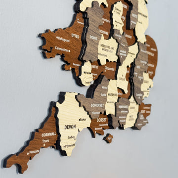 Close-up of the UK wooden wall map showing Devon, Cornwall, Dorset and Wales counties in layered wood