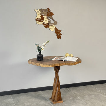 Armenia wooden map centered on a gray wall above a sculpted wooden table and vase, mid-distance view