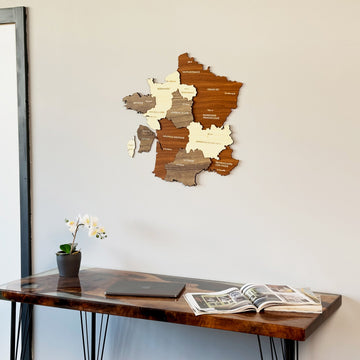 France wooden wall map, medium view above a resin desk with a laptop