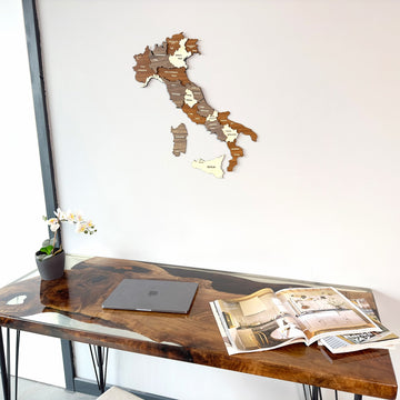 Wooden Italy map hung high above a walnut desk with a laptop, close desk view