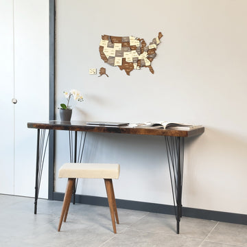 Wooden USA map above a narrow desk and stool, wide view with a white door
