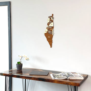 Palestine wooden wall map above a resin-edged wooden table with an open magazine, close view