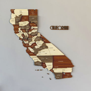 3D wooden California map with county names in cream, brown and gray layers and a separate CALIFORNIA lettering