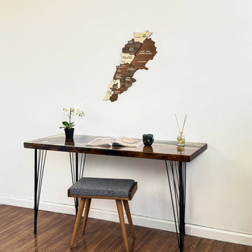 Lebanon wooden wall map above a hairpin-leg desk and upholstered stool, full room view
