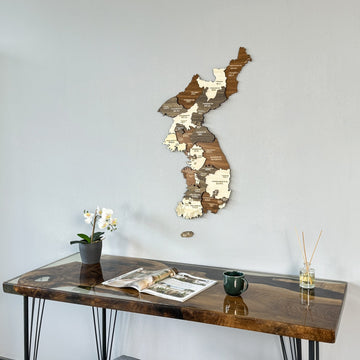 Korea wooden wall map medium view above a resin desk with a green mug
