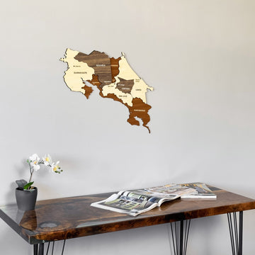 Costa Rica wooden wall map close above the end of a desk with a magazine
