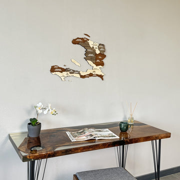Haiti wooden wall map close above the desk edge with a reed diffuser